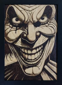 Moody yyrography of a scary clown grinning maniacally