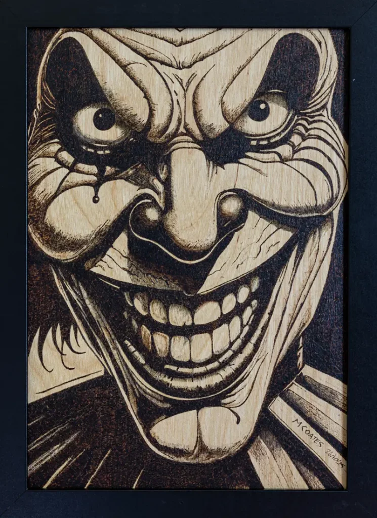 Moody yyrography of a scary clown grinning maniacally